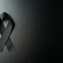top-view-of-black-bow-as-a-mourning-symbol-on-dark-wall